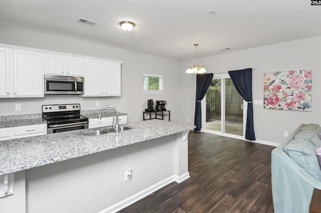 246 Harvest Glen Ln, West Columbia, SC 29169 - kitchen with stainless steel appliances, a sink, a chandelier, dark wood finished floors, and white cabinetry