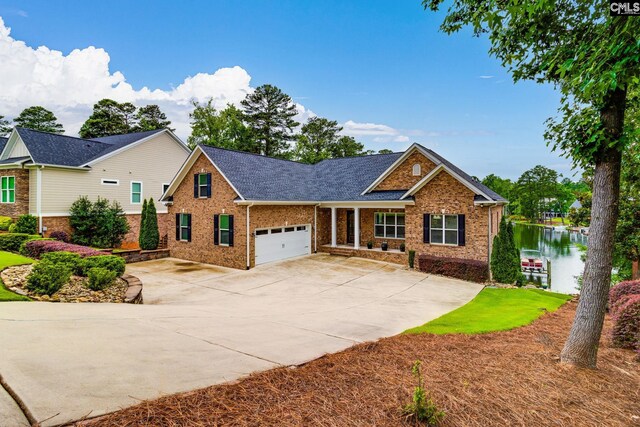 233 Pointe Overlook Dr, Chapin, SC 29036 - view of front of home with brick siding, a garage, concrete driveway, and a shingled roof