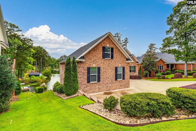 233 Pointe Overlook Dr, Chapin, SC 29036 - view of home's exterior with brick siding, a lawn, a water view, and concrete driveway