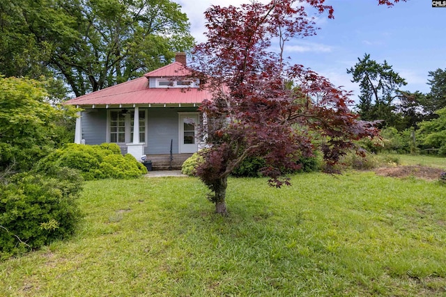 4537 State Highway 215 S, Jenkinsville, SC 29065 - view of front facade featuring covered porch, a front yard, a chimney, and metal roof