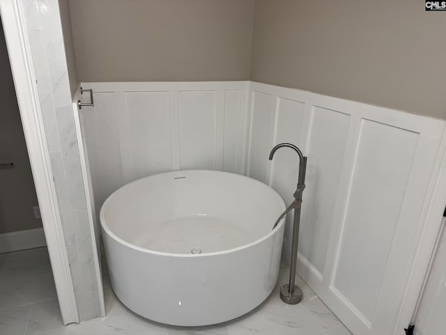 208 Juarez Ct, Columbia, SC 29206 - full bathroom with a decorative wall, a soaking tub, marble look tile flooring, and wainscoting