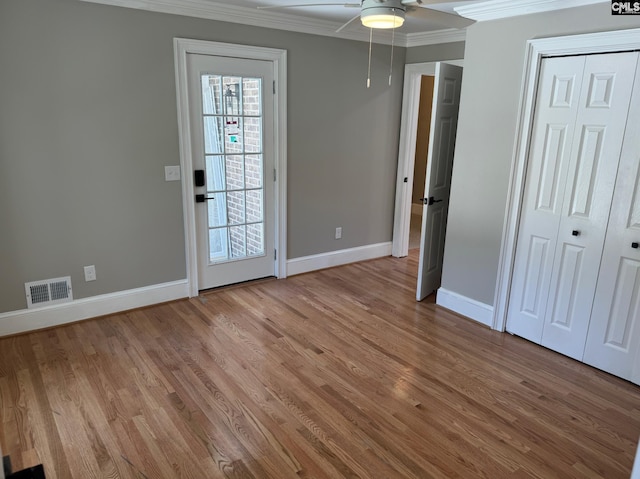 208 Juarez Ct, Columbia, SC 29206 - unfurnished bedroom featuring ornamental molding, baseboards, light wood-style floors, ceiling fan, and a closet