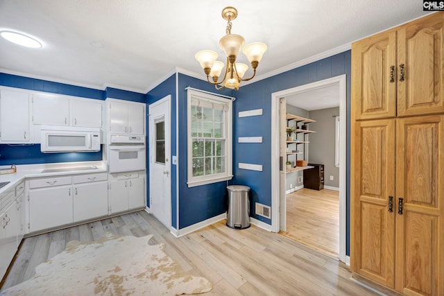 1818 Stratford Rd, Cayce, SC 29033 - kitchen featuring white appliances, crown molding, a chandelier, light wood-style floors, and light countertops