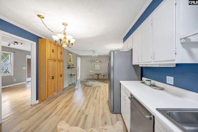 1818 Stratford Rd, Cayce, SC 29033 - kitchen with stainless steel appliances, a chandelier, white cabinetry, crown molding, and light wood-style floors