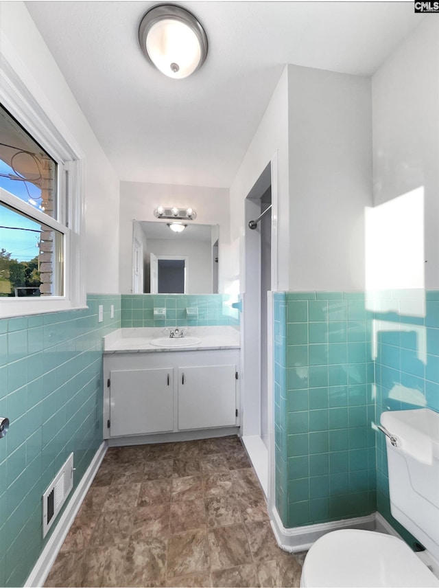 1920 Pennfield Dr, Columbia, SC 29223 - full bath featuring tile walls, toilet, vanity, a shower, and a wainscoted wall