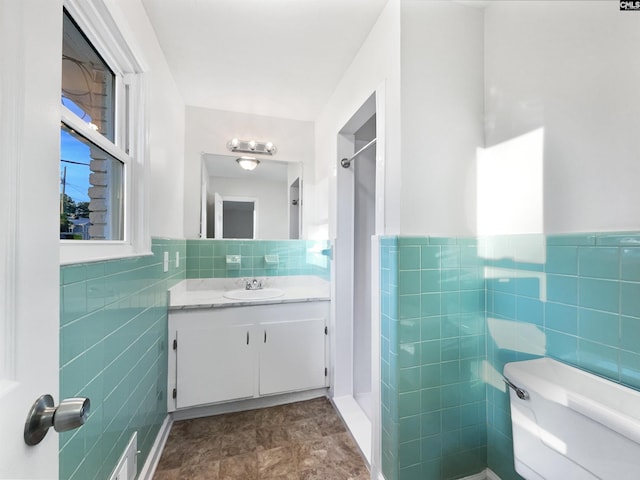 1920 Pennfield Dr, Columbia, SC 29223 - full bathroom with tile walls, toilet, vanity, a shower, and a wainscoted wall