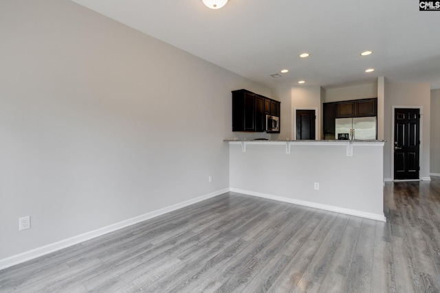 301 Chestnut Oak Ct, West Columbia, SC 29169 - kitchen featuring appliances with stainless steel finishes, recessed lighting, light wood-style flooring, baseboards, and a peninsula