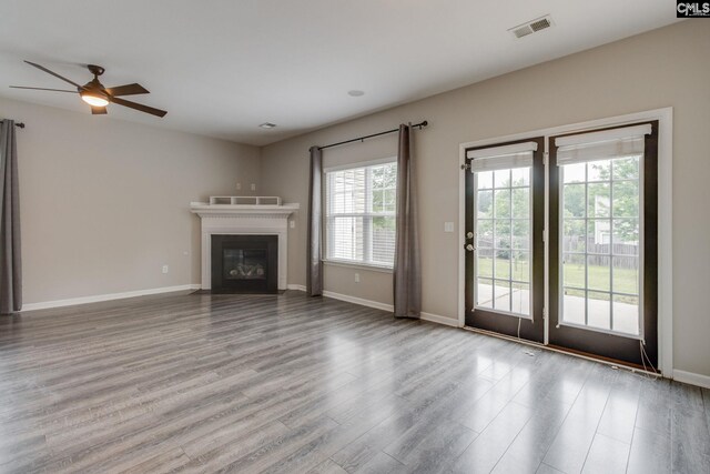 301 Chestnut Oak Ct, West Columbia, SC 29169 - unfurnished living room featuring a ceiling fan, wood finished floors, a fireplace with flush hearth, and baseboards