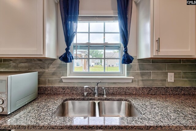 2121 Connor Way, Newberry, SC 29108 - kitchen with a sink, stone counters, and white cabinetry