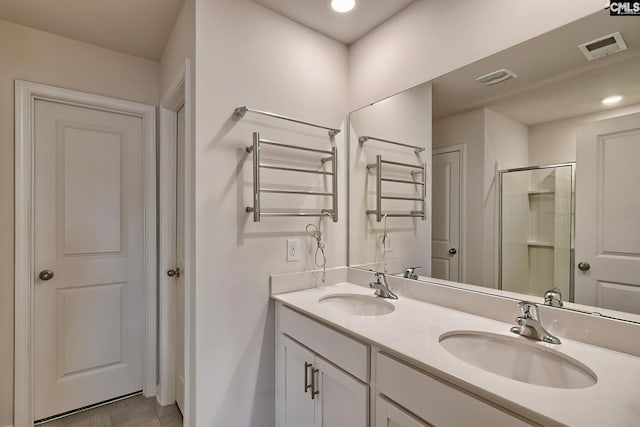 2121 Connor Way, Newberry, SC 29108 - full bath with a towel warming rack, a stall shower, double vanity, radiator, and recessed lighting