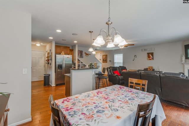 1123 Triple Crown Ct, Elgin, SC 29045 - dining room with a chandelier, light wood-style floors, stairs, and recessed lighting