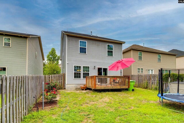 1123 Triple Crown Ct, Elgin, SC 29045 - rear view of house with a trampoline and a wooden deck
