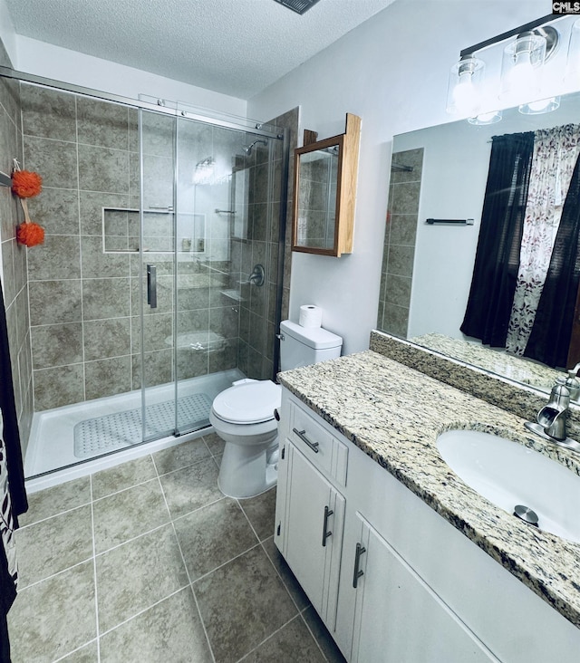 916 Sessions Rd, Elgin, SC 29045 - full bathroom featuring vanity, toilet, a shower stall, a textured ceiling, and tile patterned flooring