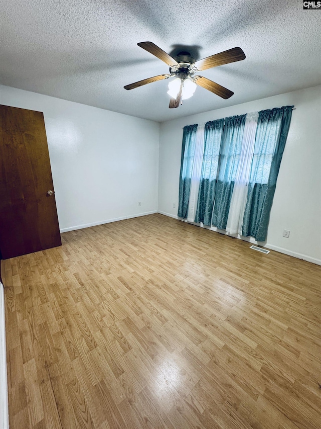 916 Sessions Rd, Elgin, SC 29045 - unfurnished room featuring a ceiling fan, wood finished floors, baseboards, and a textured ceiling