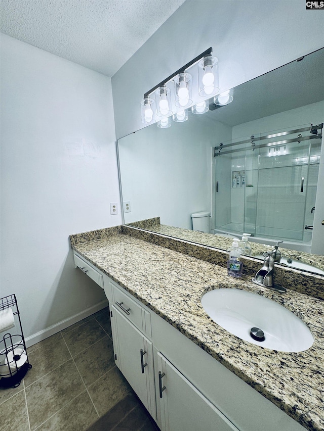 916 Sessions Rd, Elgin, SC 29045 - bathroom featuring a shower with door, baseboards, tile patterned floors, vanity, and a textured ceiling