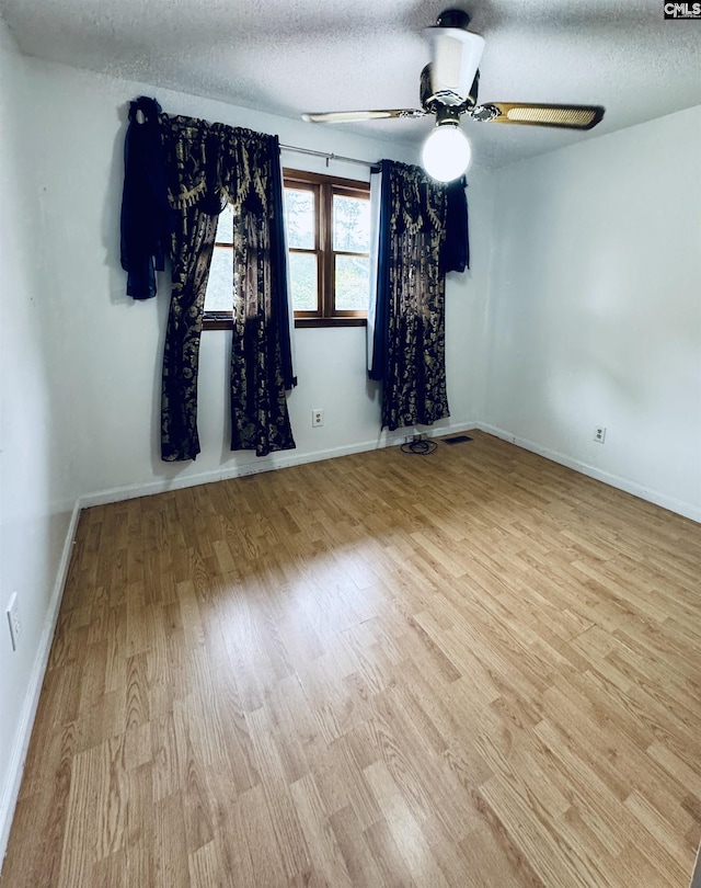 916 Sessions Rd, Elgin, SC 29045 - empty room featuring wood finished floors, a ceiling fan, a textured ceiling, and baseboards