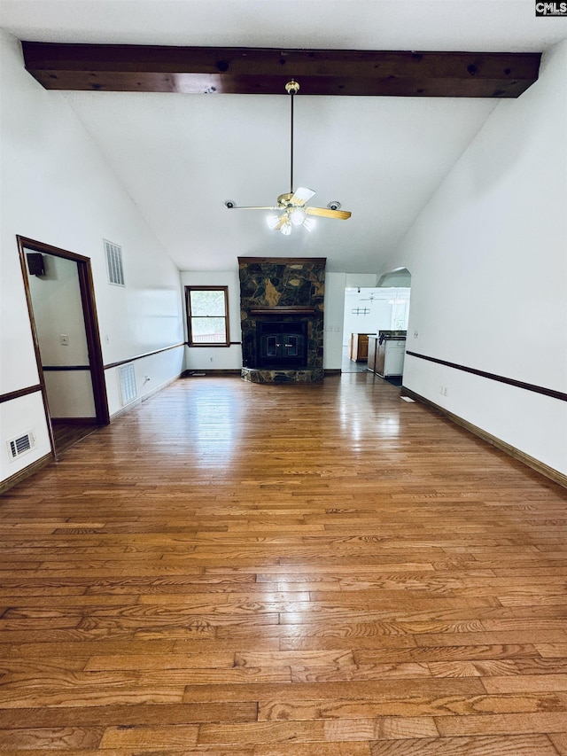 916 Sessions Rd, Elgin, SC 29045 - unfurnished living room featuring a ceiling fan, beamed ceiling, baseboards, a large fireplace, and wood finished floors