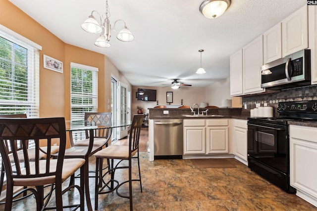 209 Walden Place Cir, Elgin, SC 29045 - kitchen with appliances with stainless steel finishes, dark countertops, a sink, a peninsula, and tasteful backsplash