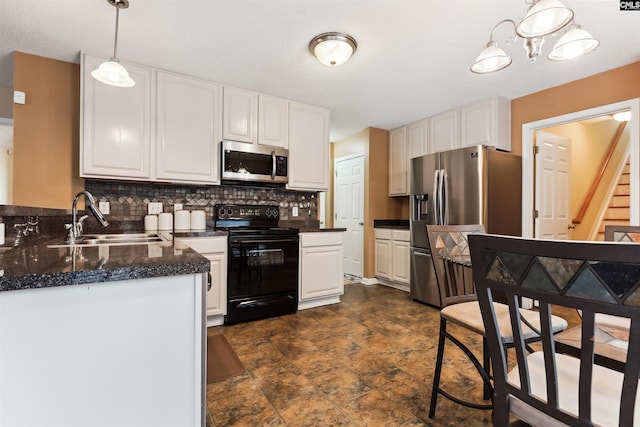 209 Walden Place Cir, Elgin, SC 29045 - kitchen featuring appliances with stainless steel finishes, a sink, white cabinets, decorative backsplash, and decorative light fixtures