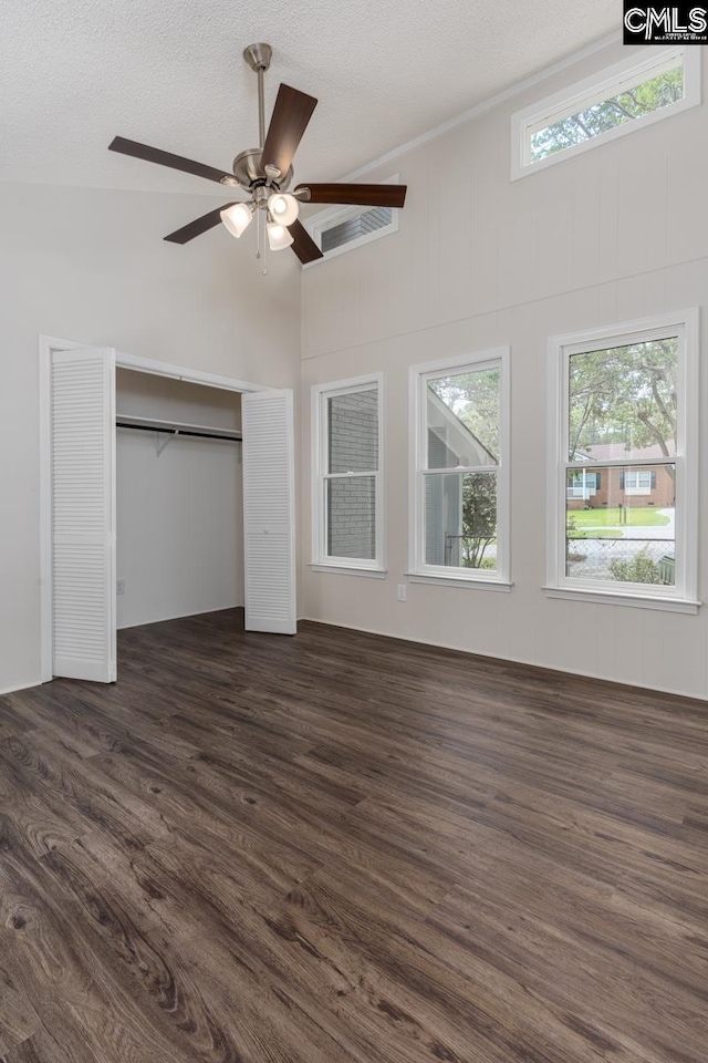 2308 Exton Shore Dr, Columbia, SC 29209 - unfurnished bedroom featuring dark wood-style floors, a closet, a textured ceiling, high vaulted ceiling, and a ceiling fan