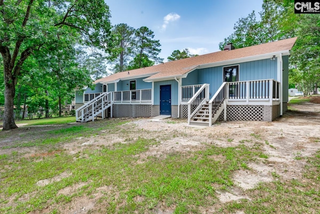 2308 Exton Shore Dr, Columbia, SC 29209 - view of front of house with a chimney, roof with shingles, and stairway