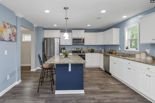 53 Findlay Cir, Elgin, SC 29045 - kitchen with appliances with stainless steel finishes, white cabinets, a breakfast bar area, light stone countertops, and baseboards