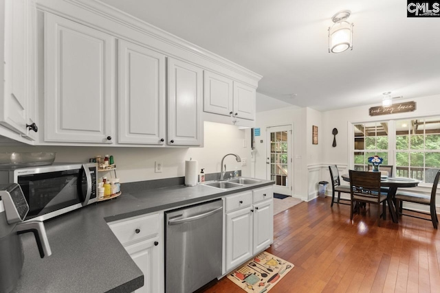 612 Williams Cir, West Columbia, SC 29172 - kitchen with stainless steel appliances, a sink, white cabinets, and dark countertops