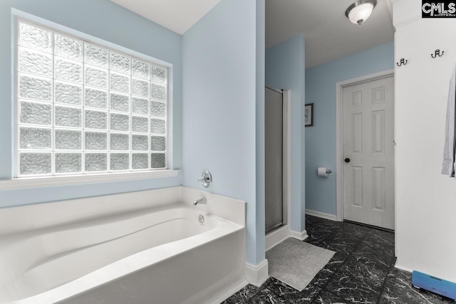 612 Williams Cir, West Columbia, SC 29172 - bathroom with a bath, marble look tile flooring, a shower stall, and baseboards