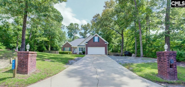 612 Williams Cir, West Columbia, SC 29172 - view of front facade featuring a front yard, driveway, brick siding, an attached garage, and view of scattered trees