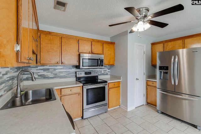 11 Parkhaven Ct, Columbia, SC 29209 - kitchen with stainless steel appliances, a sink, light countertops, backsplash, and a textured ceiling