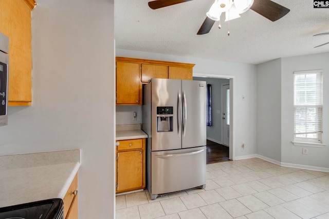 11 Parkhaven Ct, Columbia, SC 29209 - kitchen featuring stainless steel refrigerator with ice dispenser, a ceiling fan, light countertops, light tile patterned floors, and a textured ceiling