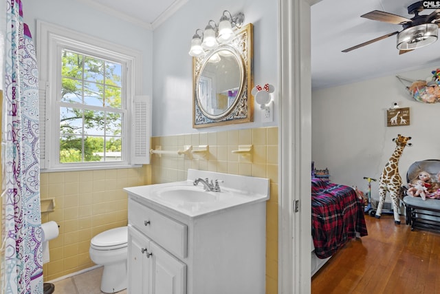 303 N Rudolph St, Saluda, SC 29138 - bathroom featuring tile walls, vanity, ornamental molding, ceiling fan, and toilet