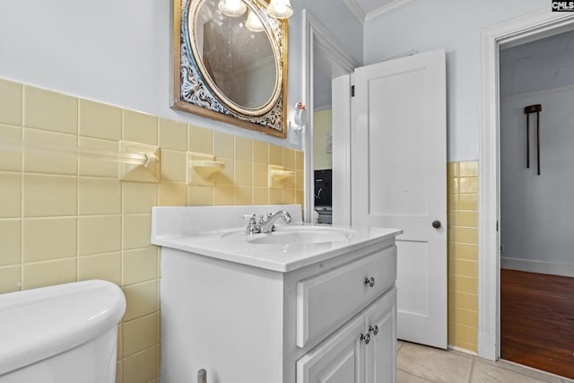 303 N Rudolph St, Saluda, SC 29138 - half bath with tile walls, vanity, toilet, tile patterned floors, and ornamental molding