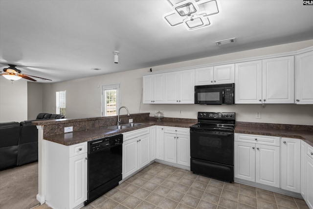 175 Rosecliff Cir, Hopkins, SC 29061 - kitchen with black appliances, a sink, a peninsula, open floor plan, and white cabinets