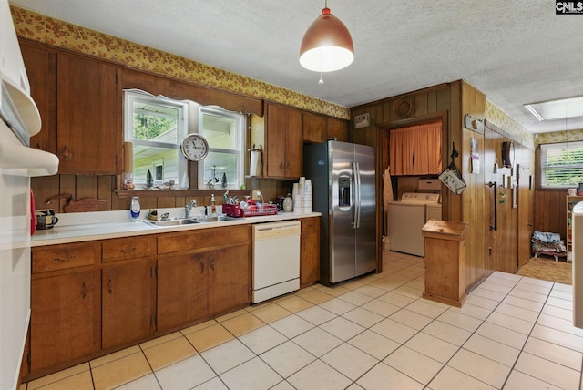 2015 Valley View Rd, West Columbia, SC 29172 - kitchen featuring stainless steel fridge, white dishwasher, a sink, independent washer and dryer, and light countertops