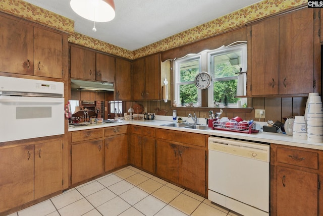 2015 Valley View Rd, West Columbia, SC 29172 - kitchen with white appliances, light countertops, a sink, under cabinet range hood, and light tile patterned flooring