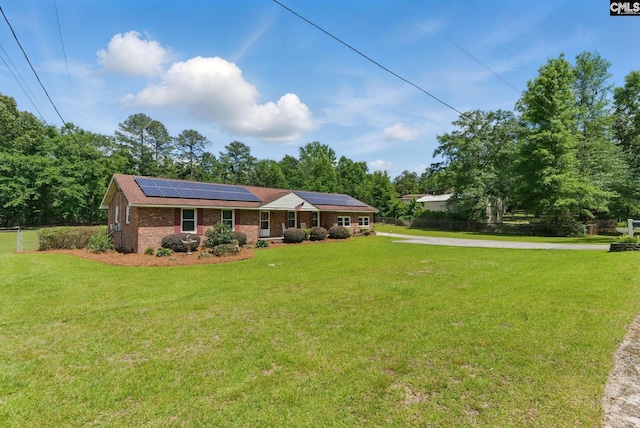 2015 Valley View Rd, West Columbia, SC 29172 - single story home featuring solar panels, brick siding, driveway, and view of scattered trees