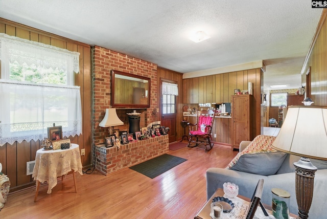 2015 Valley View Rd, West Columbia, SC 29172 - living area featuring light wood finished floors, a textured ceiling, and wooden walls