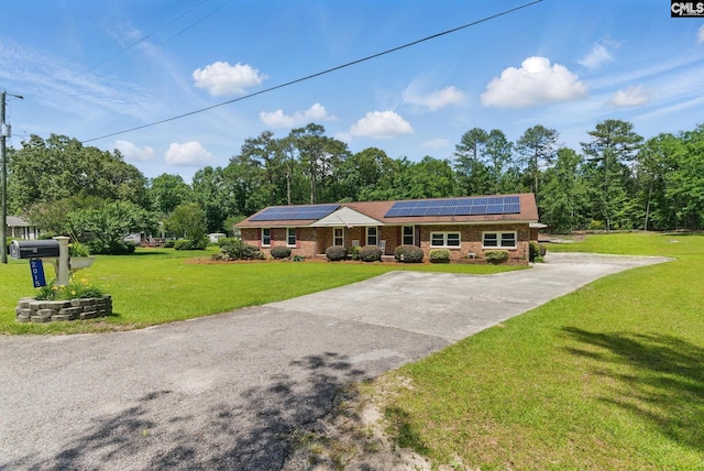 2015 Valley View Rd, West Columbia, SC 29172 - view of front facade featuring solar panels, a front yard, brick siding, and driveway