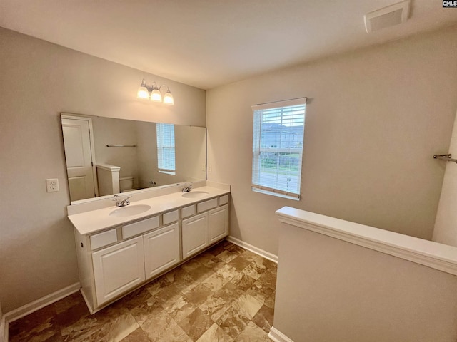 1069 Roscoe Rd, Lexington, SC 29073 - bathroom featuring double vanity, baseboards, and toilet