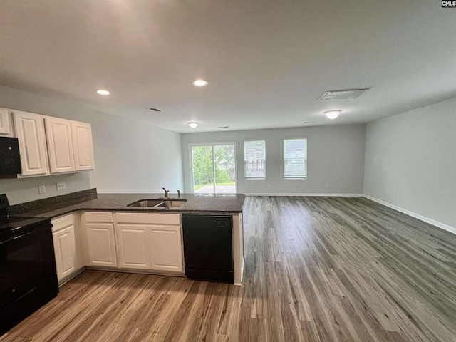 1069 Roscoe Rd, Lexington, SC 29073 - kitchen featuring black appliances, light wood-style flooring, a sink, a peninsula, and open floor plan