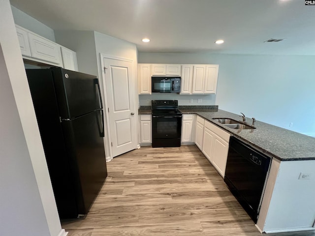 1069 Roscoe Rd, Lexington, SC 29073 - kitchen featuring black appliances, a sink, a peninsula, light wood finished floors, and white cabinets