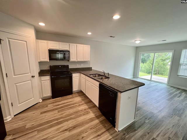 1069 Roscoe Rd, Lexington, SC 29073 - kitchen with black appliances, a sink, a peninsula, light wood-style flooring, and recessed lighting
