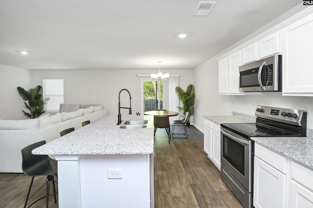 341 Liliana Dr, Columbia, SC 29223 - kitchen with appliances with stainless steel finishes, a breakfast bar area, a sink, a chandelier, and white cabinets