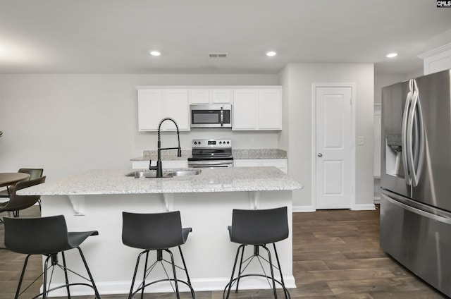 341 Liliana Dr, Columbia, SC 29223 - kitchen with stainless steel appliances, a sink, white cabinetry, light stone countertops, and recessed lighting