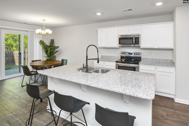 341 Liliana Dr, Columbia, SC 29223 - kitchen with appliances with stainless steel finishes, a sink, a chandelier, dark wood-style floors, and white cabinetry