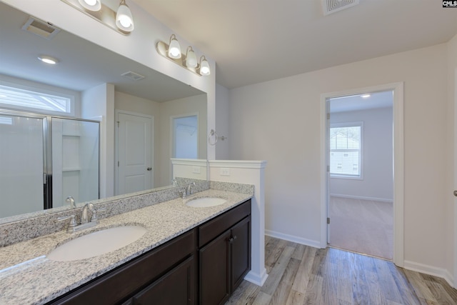 812 Poplar Bend Rd, Columbia, SC 29229 - bathroom with double vanity, wood finished floors, baseboards, and a shower with door