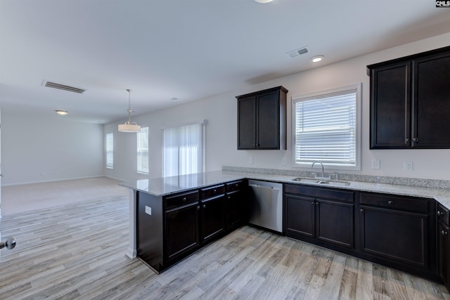 812 Poplar Bend Rd, Columbia, SC 29229 - kitchen with stainless steel dishwasher, a sink, a peninsula, light wood-type flooring, and light stone countertops