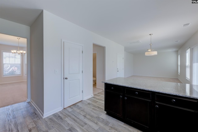 812 Poplar Bend Rd, Columbia, SC 29229 - kitchen with dark cabinetry, a chandelier, light wood-style floors, and plenty of natural light