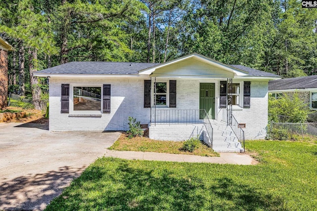 198 Stanford St, Columbia, SC 29203 - view of front of house with a porch, brick siding, and driveway